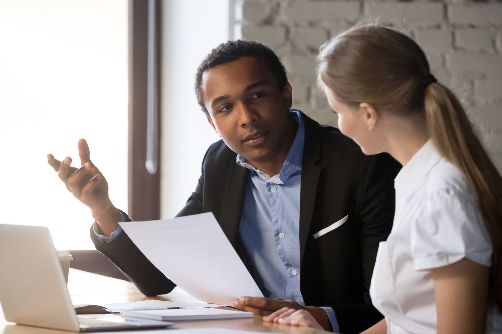 Man showing documents to woman