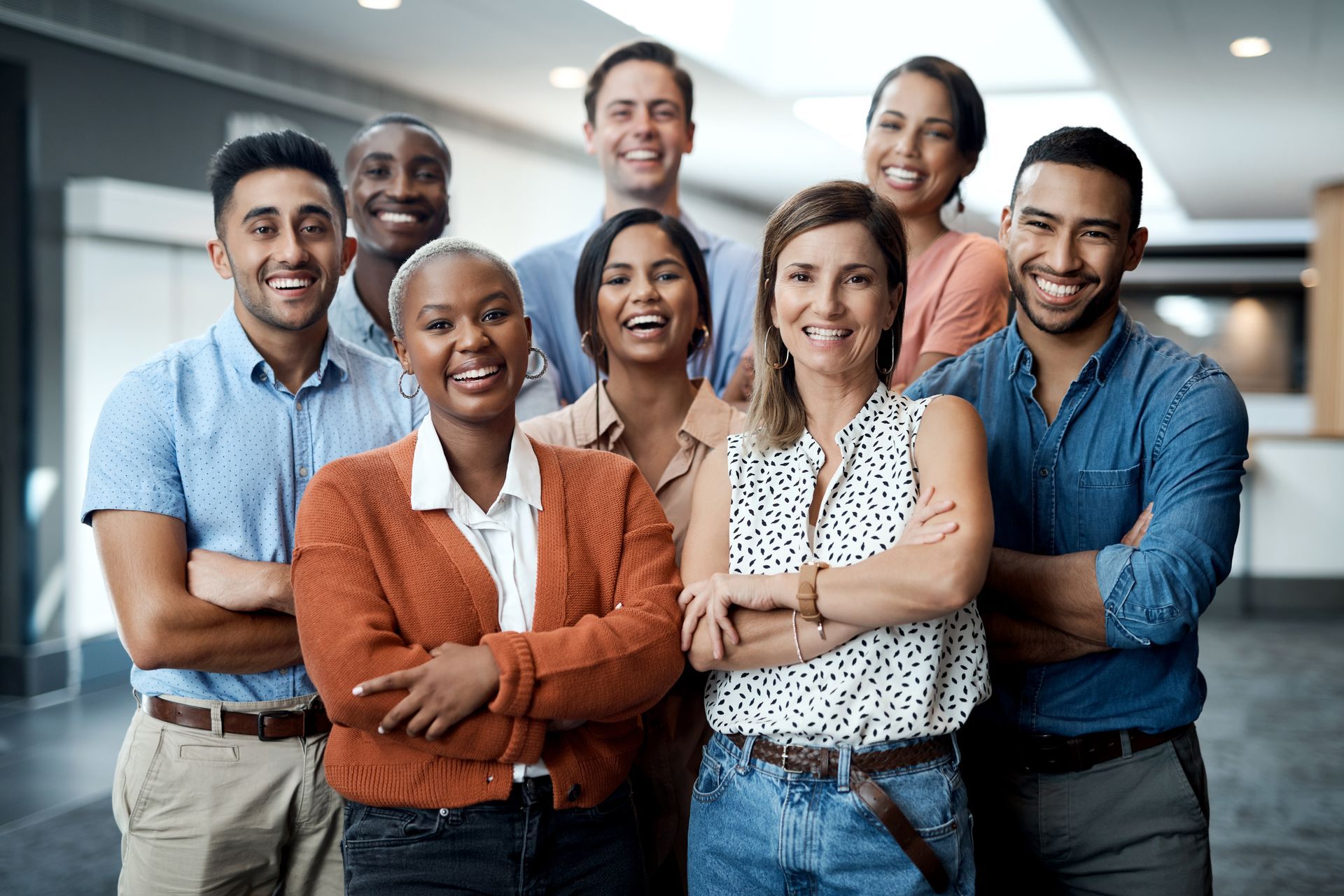 Group of diverse colleagues smiling with arms crossed