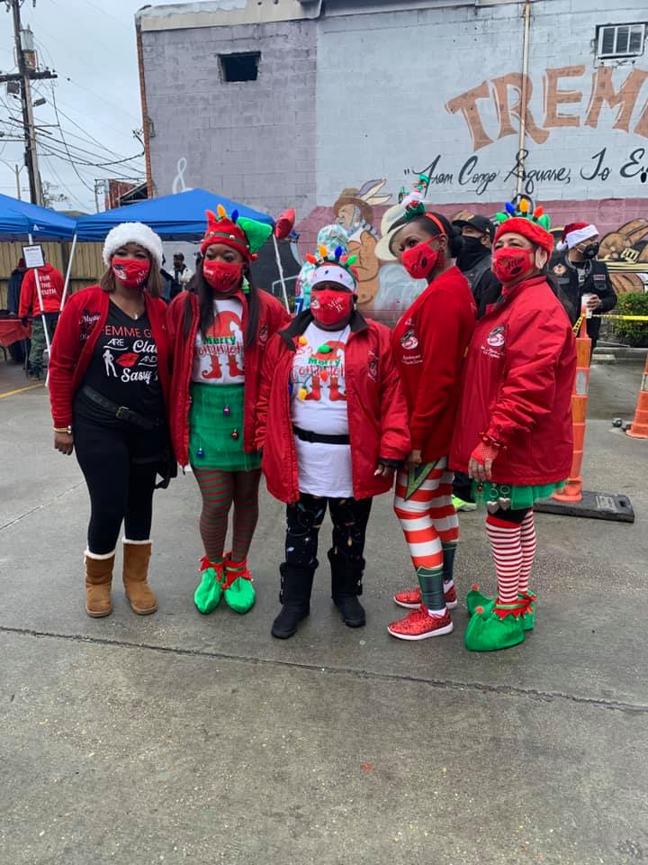 A group of people wearing face masks are standing next to each other.