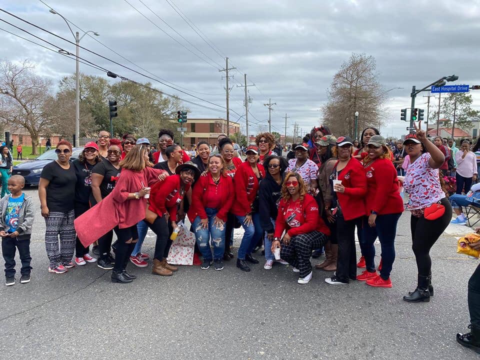 A group of people are posing for a picture in a parade.