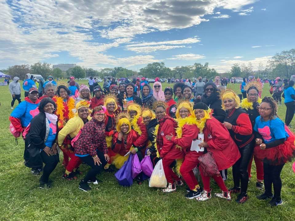 A group of people are posing for a picture in a field.