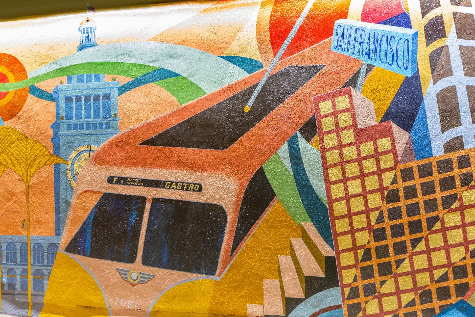 Colorful mural: Orange trolley car, Big Ben, and gold-grid building against a speckled background.