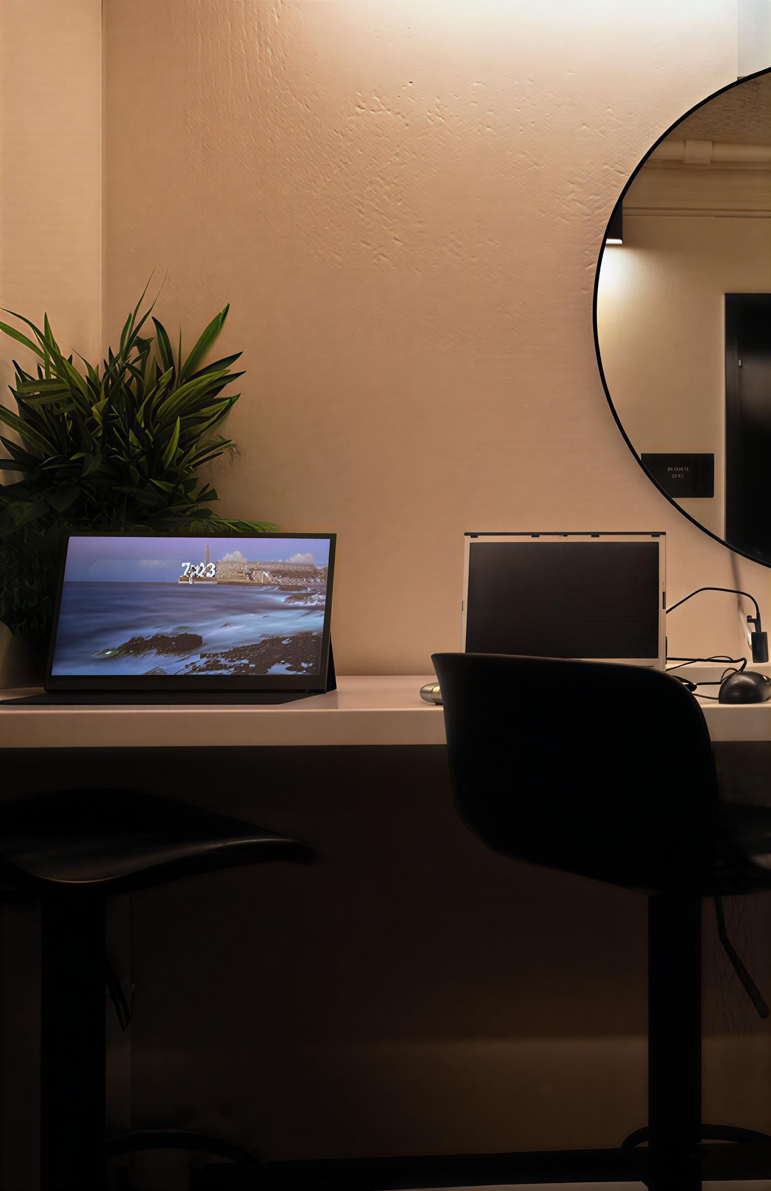 Dark green office interior with a kitchenette and open doorway.