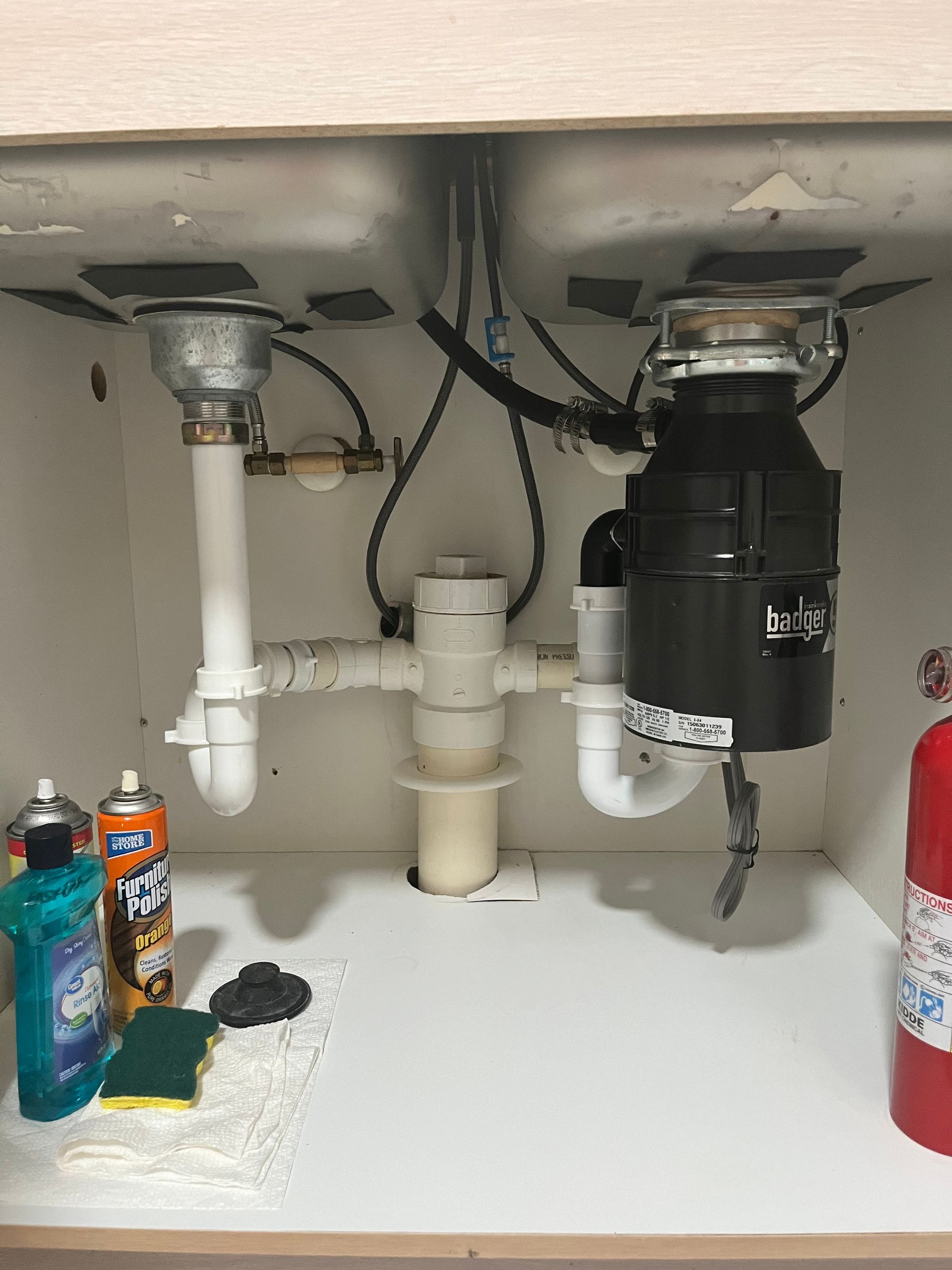 A kitchen sink with a garbage disposal underneath it