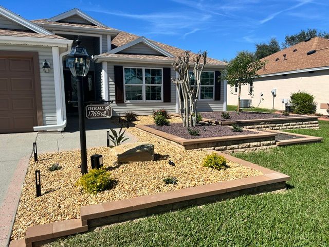 A house with two garage doors and a concrete driveway