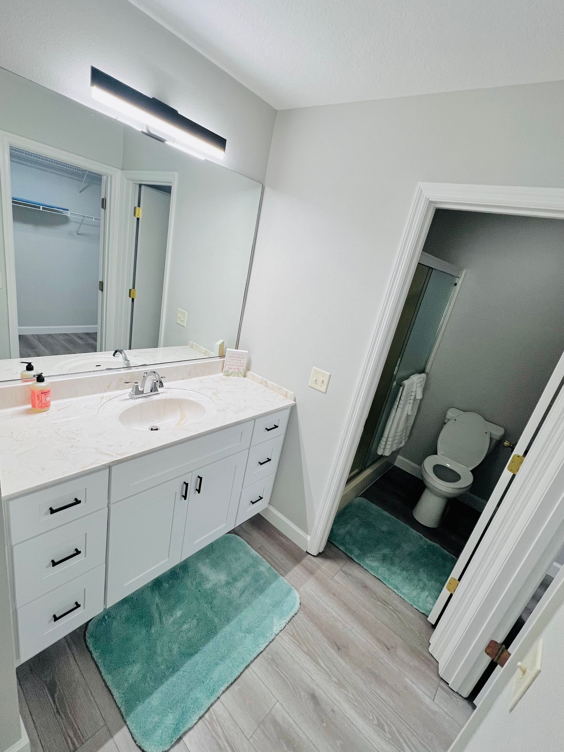 A bathroom with a sink , toilet , and mirror.