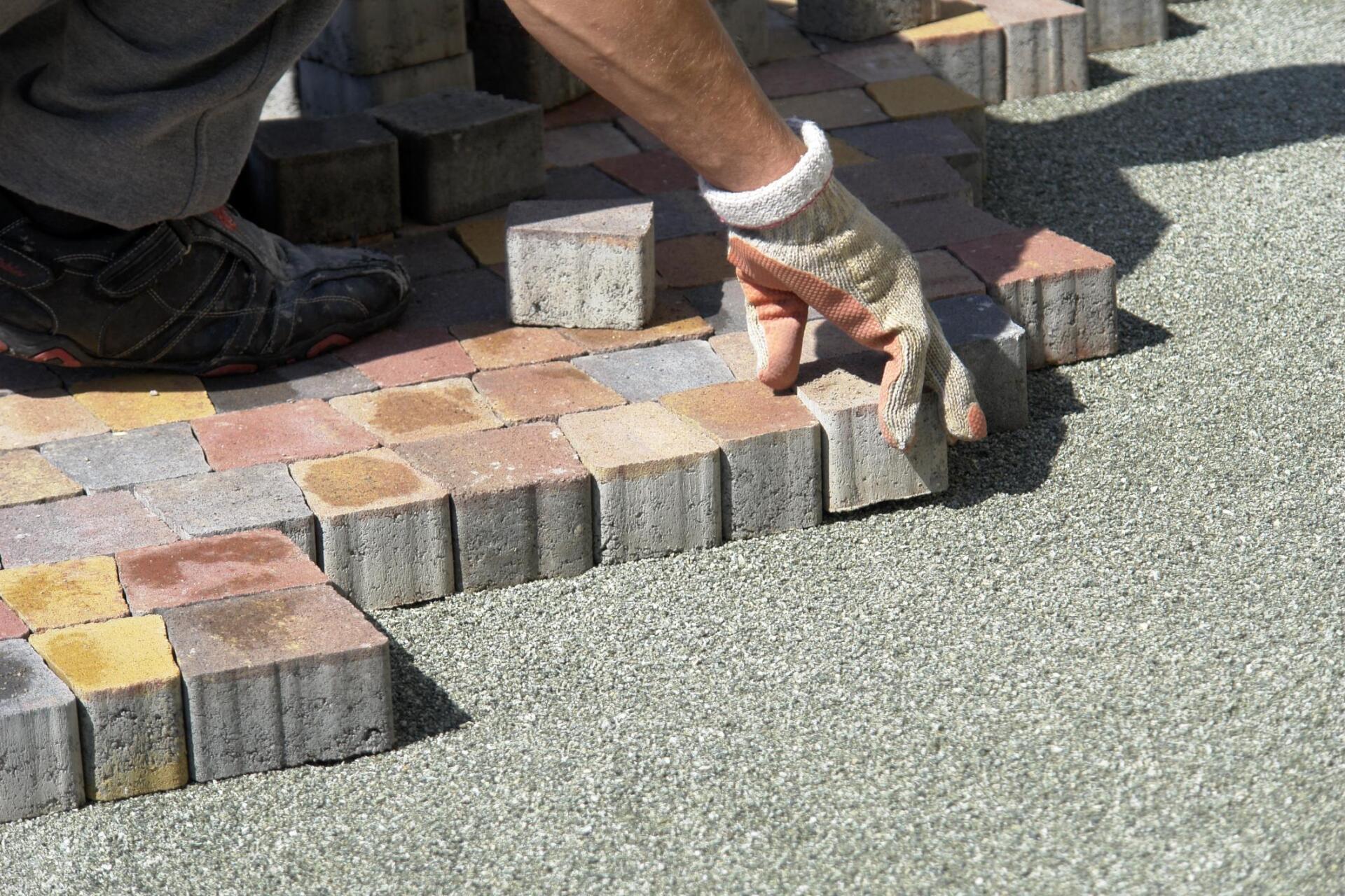man installing concrete blocks