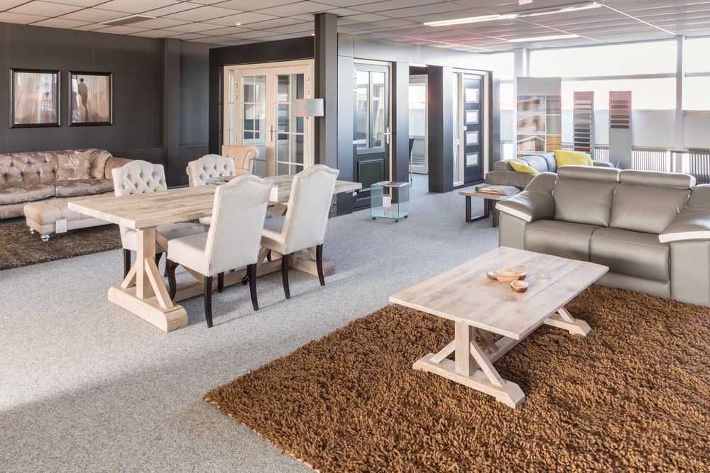 A Living Room With a Table and Chairs and a Coffee Table — Paul Cooper Homes In Noosa Heads, QLD