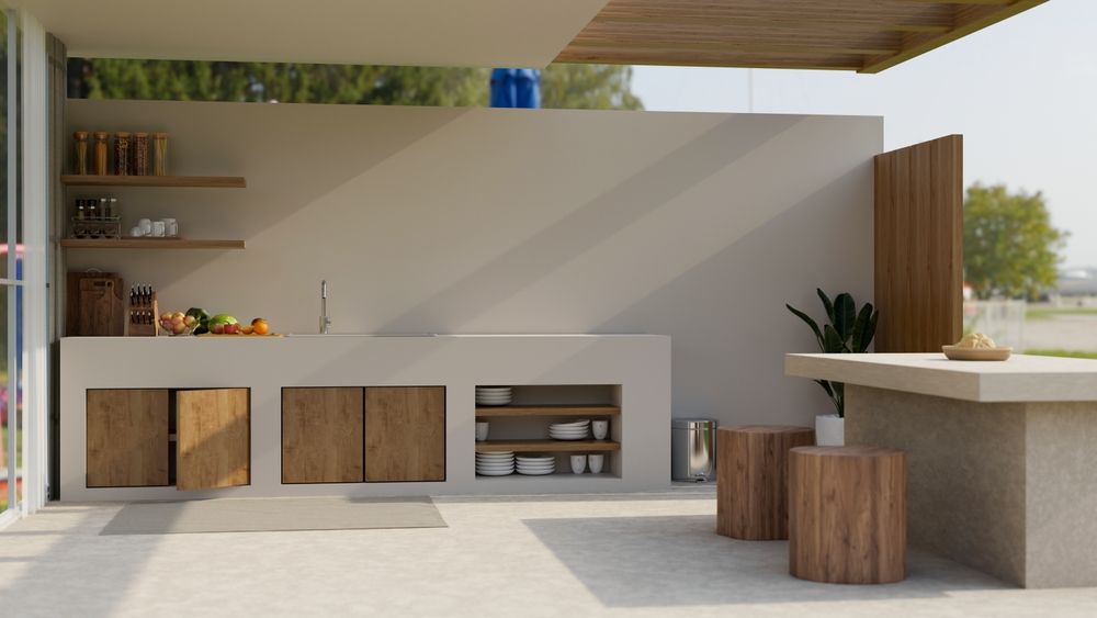 An Outside Kitchen With a Sink, Cabinets, Stools and a Table — Paul Cooper Homes In Noosa Heads, QLD