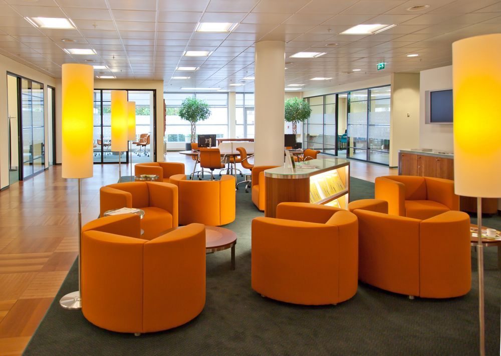 A Living Room With Orange Chairs and Lamps — Paul Cooper Homes In Noosa Heads, QLD