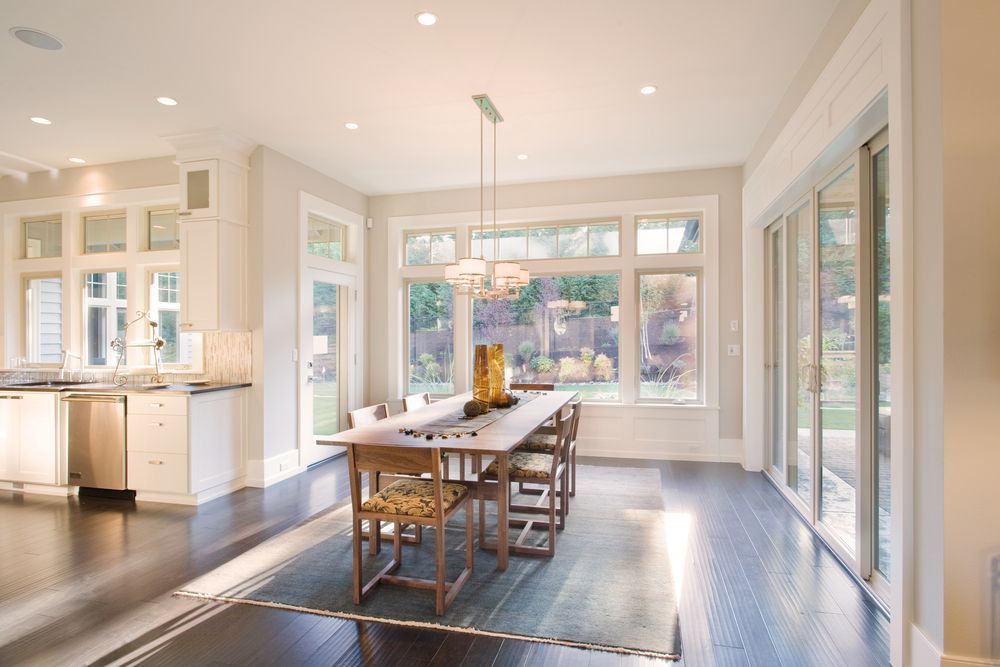 A Dining Room With a Table and Chairs and Lots of Windows — Paul Cooper Homes In Noosa Heads, QLD