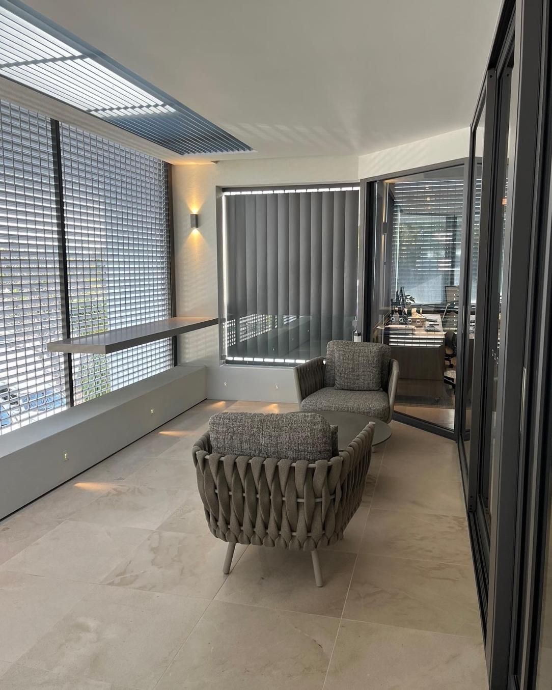 A Man is Standing on a Ladder Painting a Building — Paul Cooper Homes In Noosa Heads, QLD