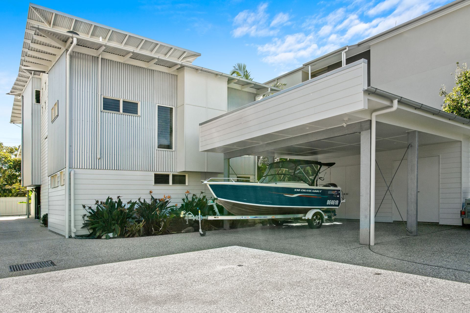 There Are Two Chairs And A Table On The Balcony — Paul Cooper Homes In Noosa Heads, QLD