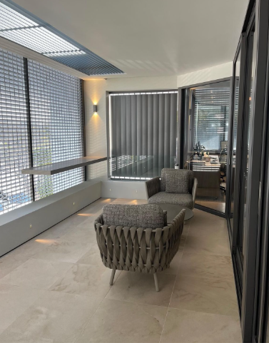 There is a Chair and a Table on the Balcony — Paul Cooper Homes In Noosa Heads, QLD