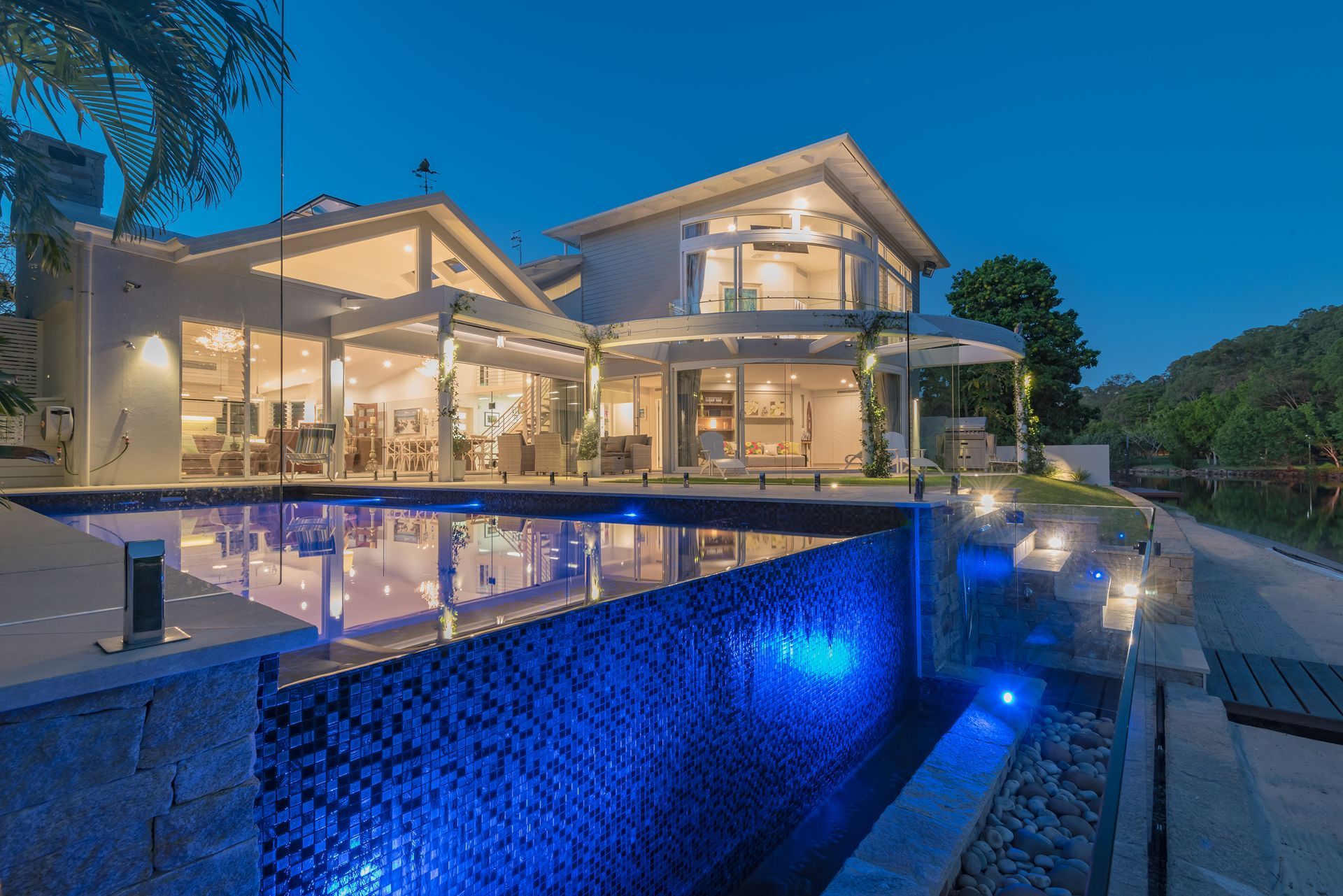 A White and Blue Bed Next to an Open Window — Paul Cooper Homes In Noosa Heads, QLD