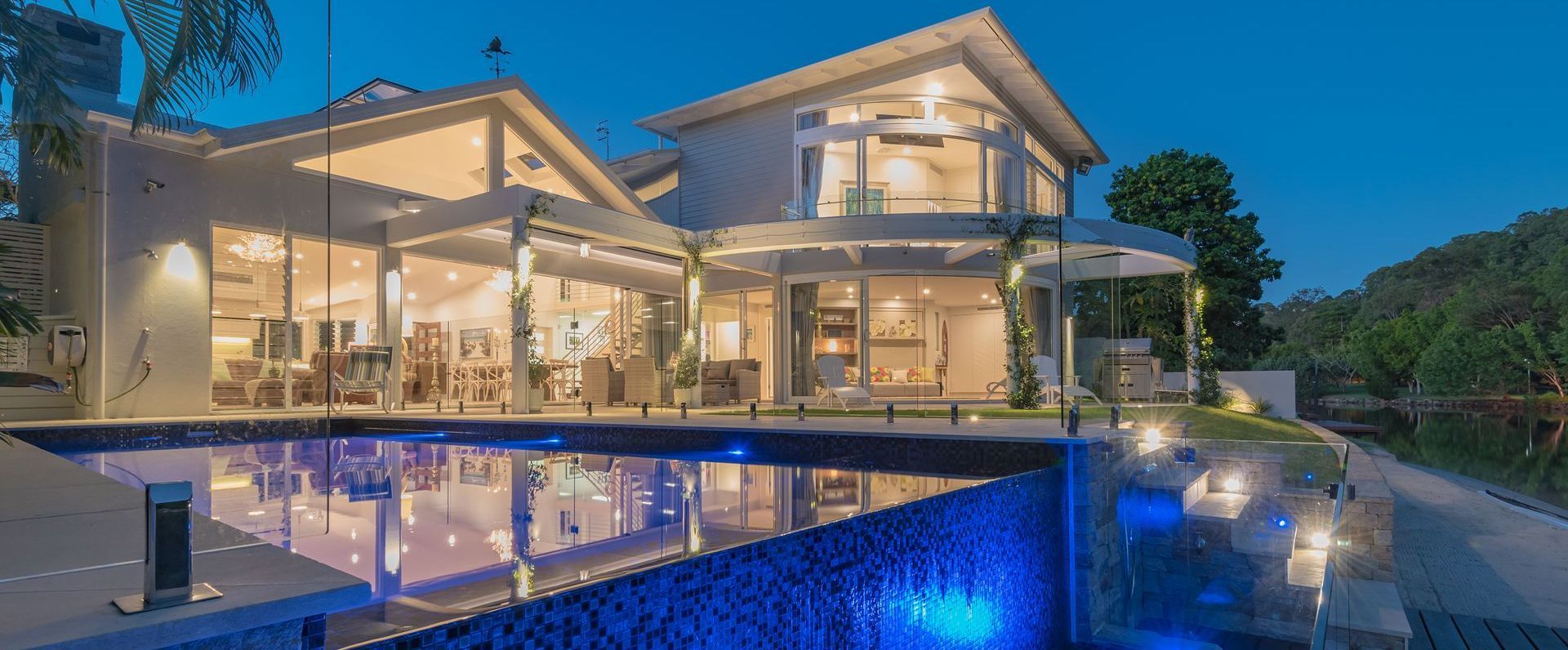 A Kitchen With Stainless Steel Appliances and a Large Island — Paul Cooper Homes In Noosa Heads, QLD