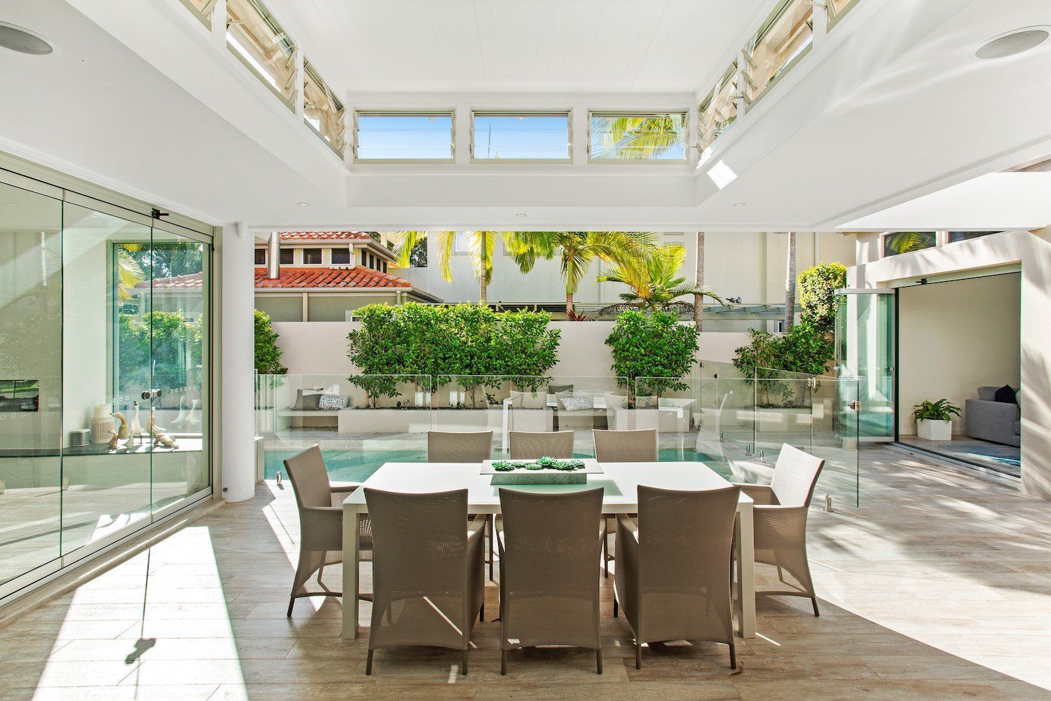 A Kitchen With a Table and Chairs and a Television on the Wall — Paul Cooper Homes In Noosa Heads, QLD