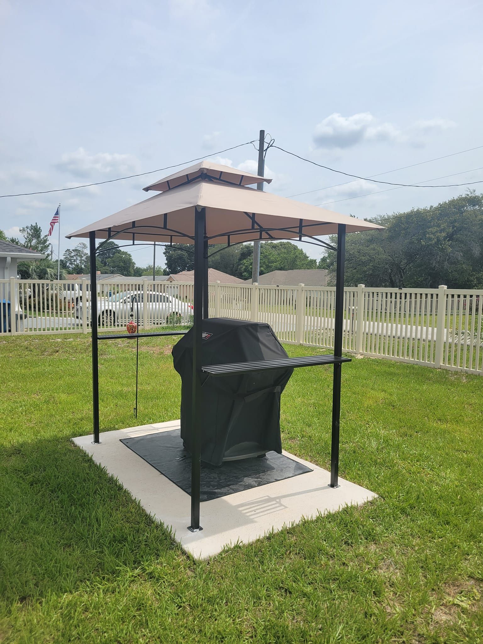 A man is blowing leaves in a park with a leaf blower.