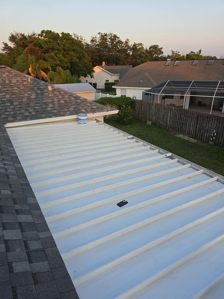 A white metal roof is sitting on top of a brick roof.