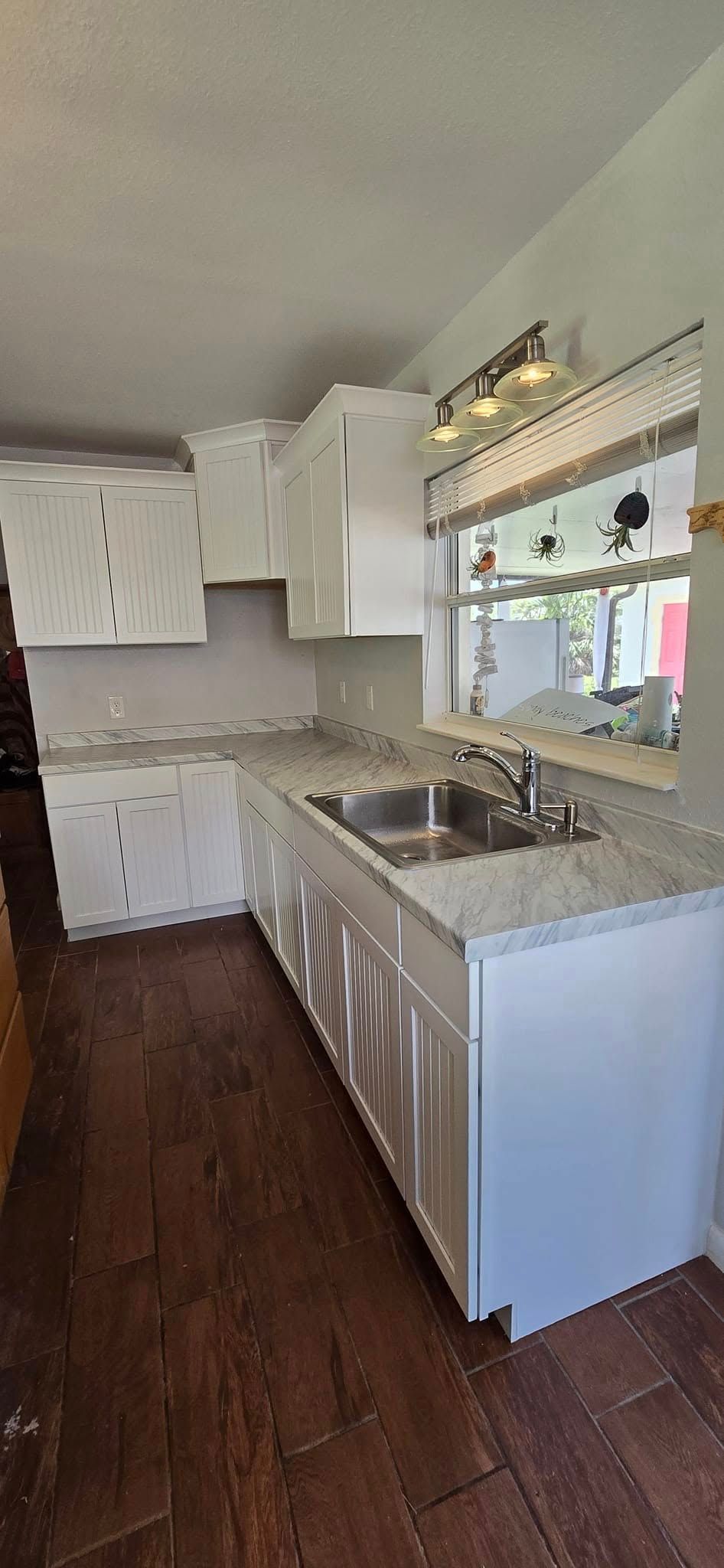 A lush green field with trees in the background.