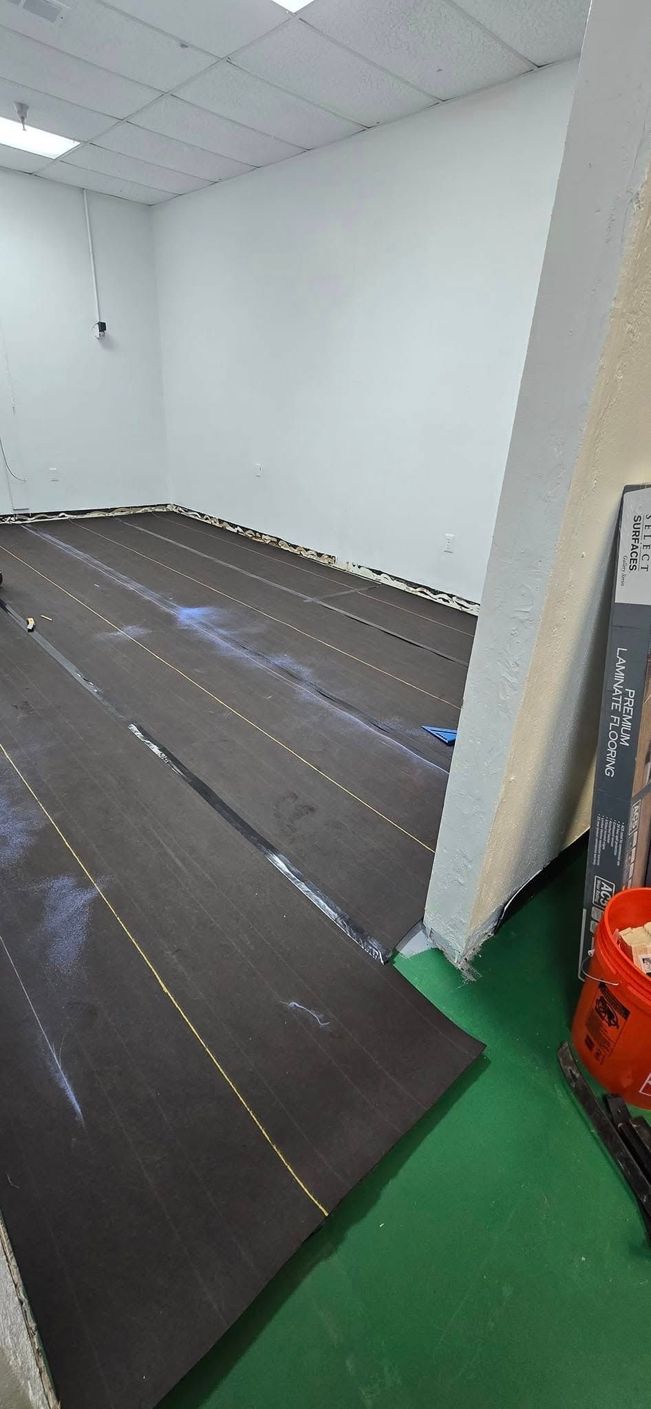 A room with a carpeted floor and a white wall.