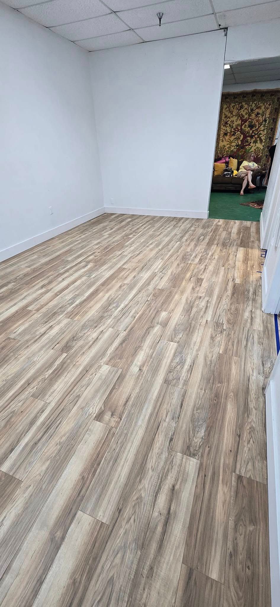 A room with a wooden floor and white walls.