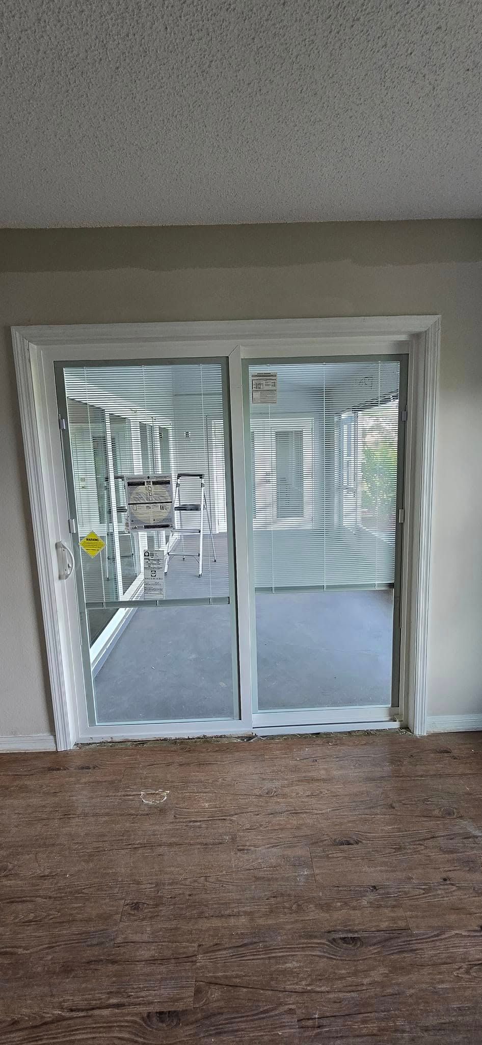 A living room with a sliding glass door leading to a balcony.