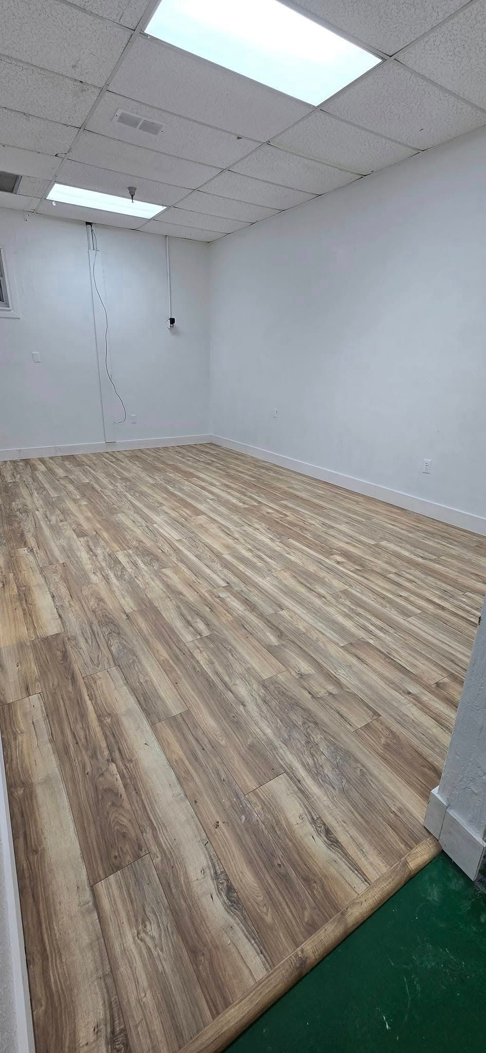 A sidewalk with grass growing on the side of it