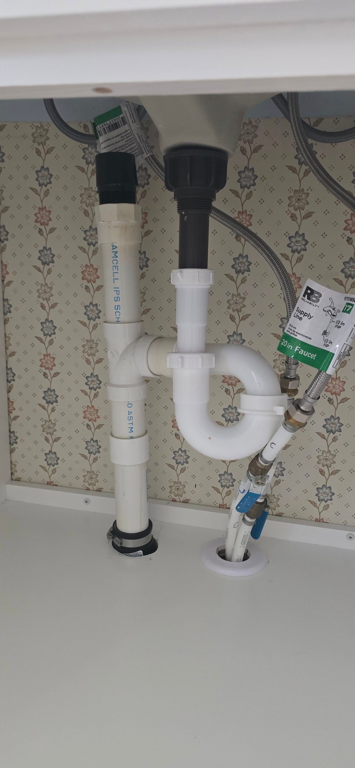 A sink with a p trap underneath it.