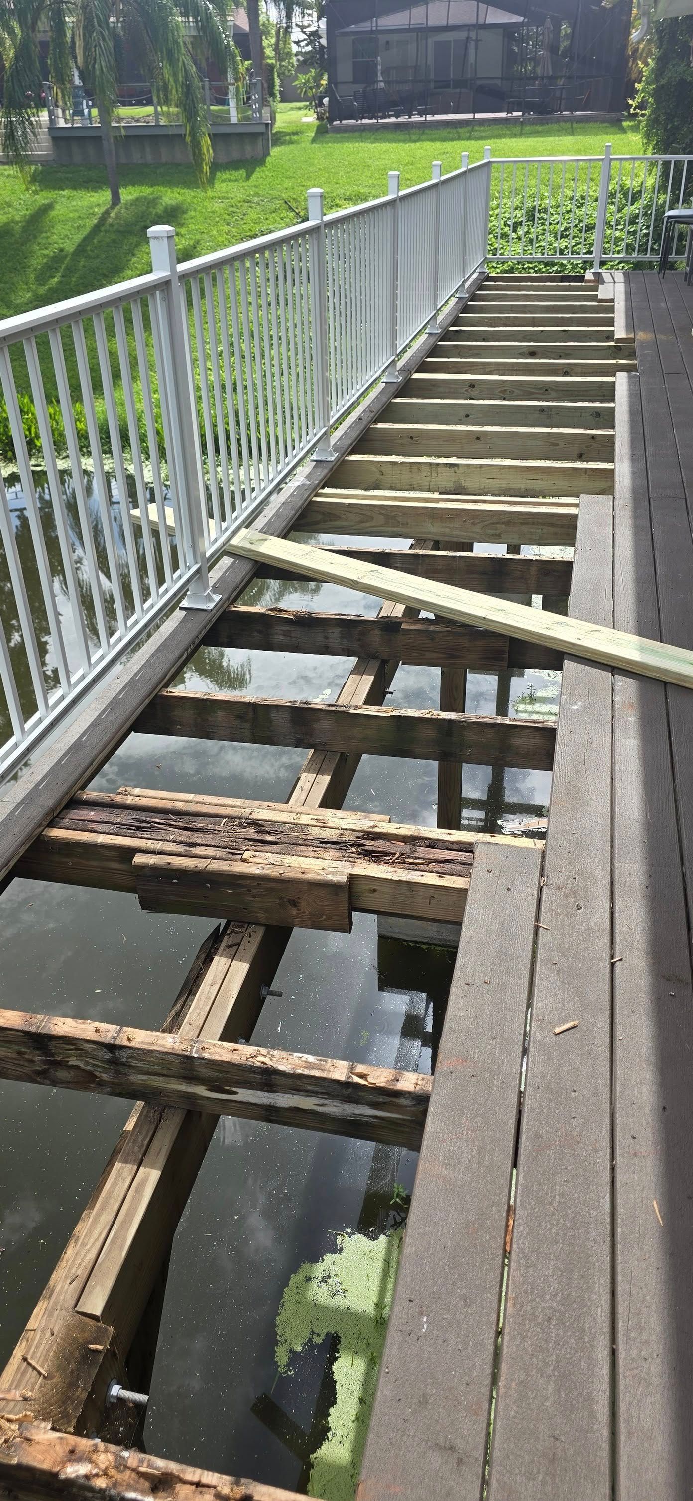 A wooden bridge is being built over a body of water.