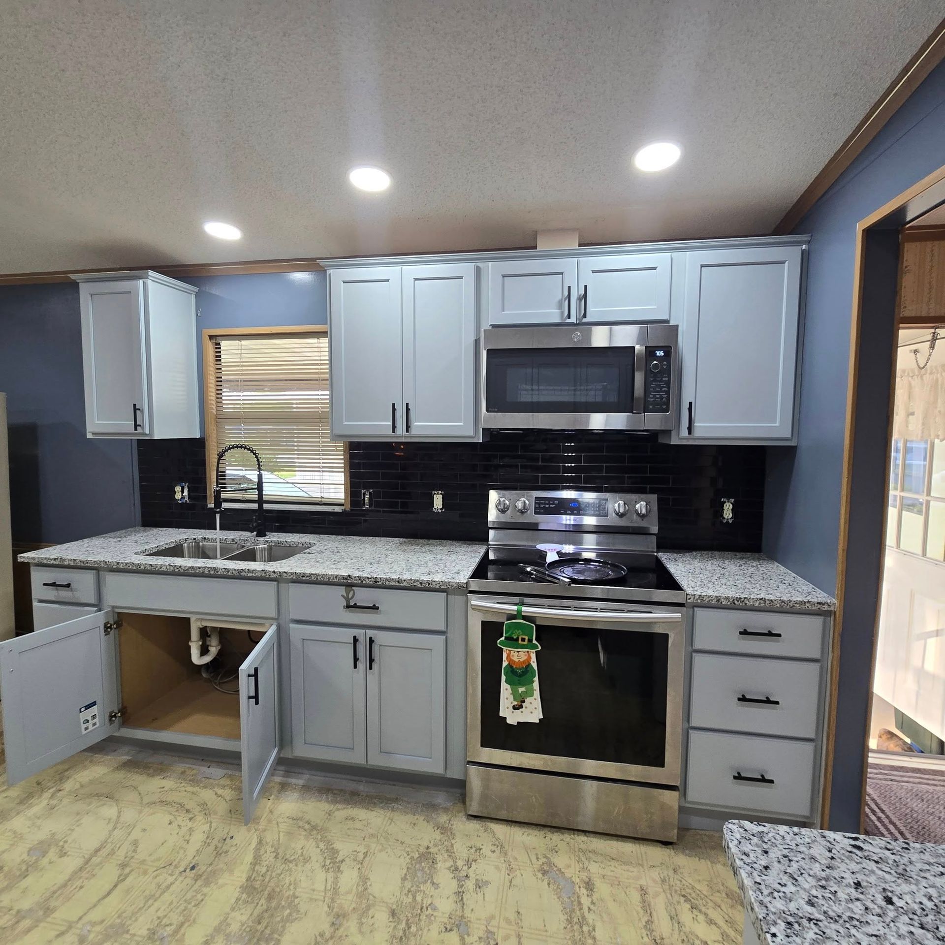 A kitchen with stainless steel appliances and white cabinets