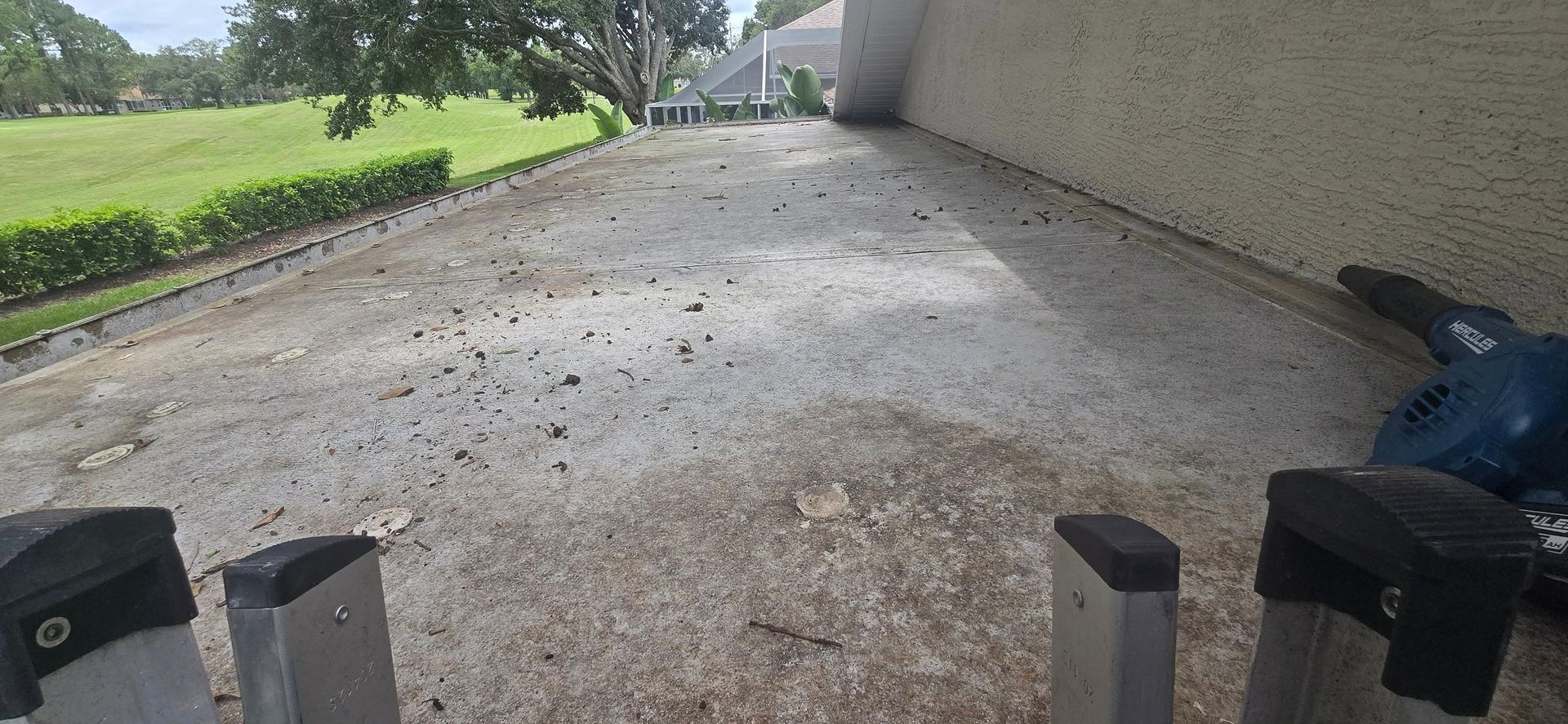 A ladder is sitting on the ground next to a wall.