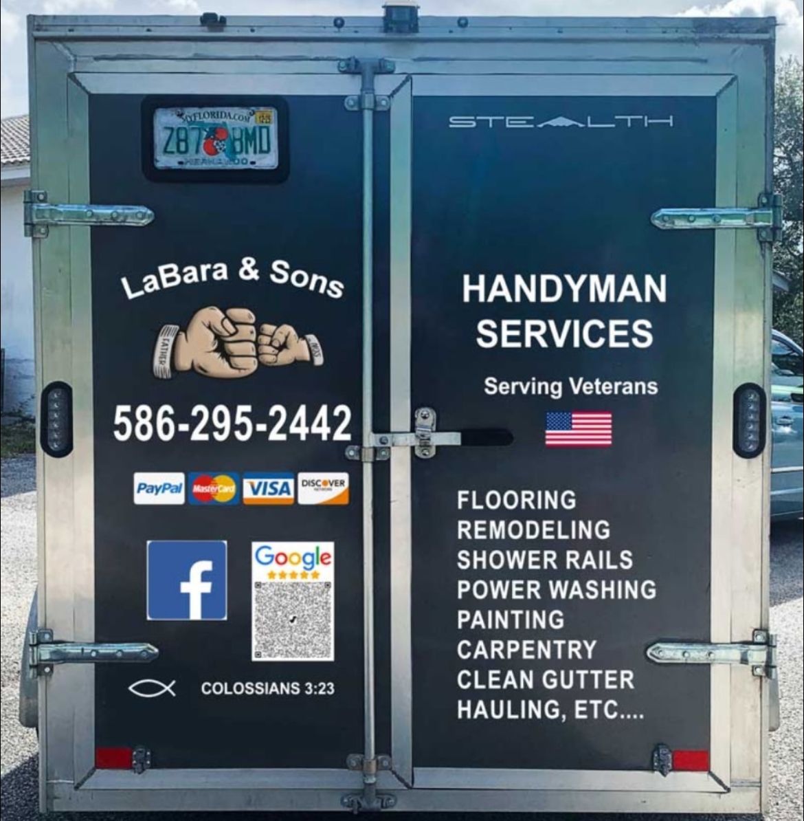 The back of a trailer advertising handyman services