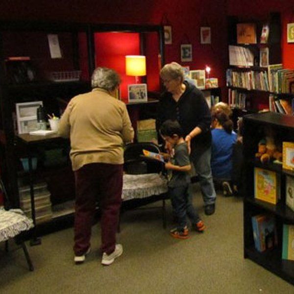 Adults with children in a book room