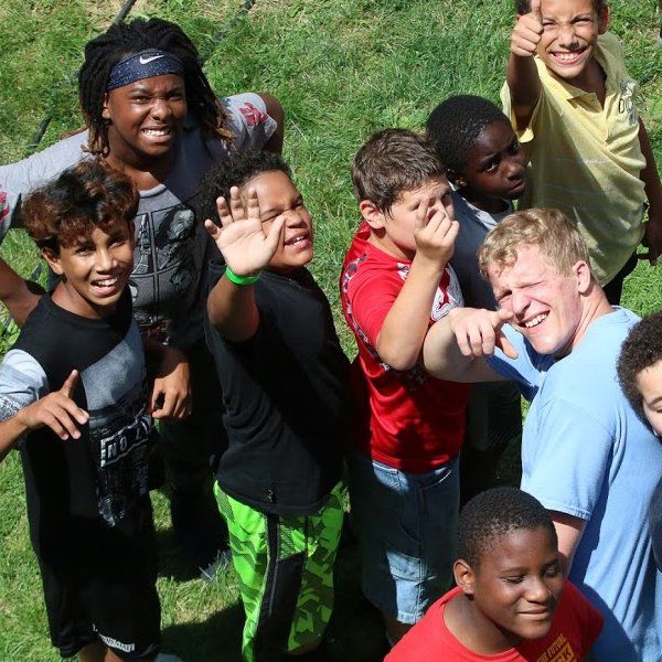 Youths smiling up at the camera