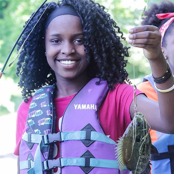 Teenager holding a caught fish