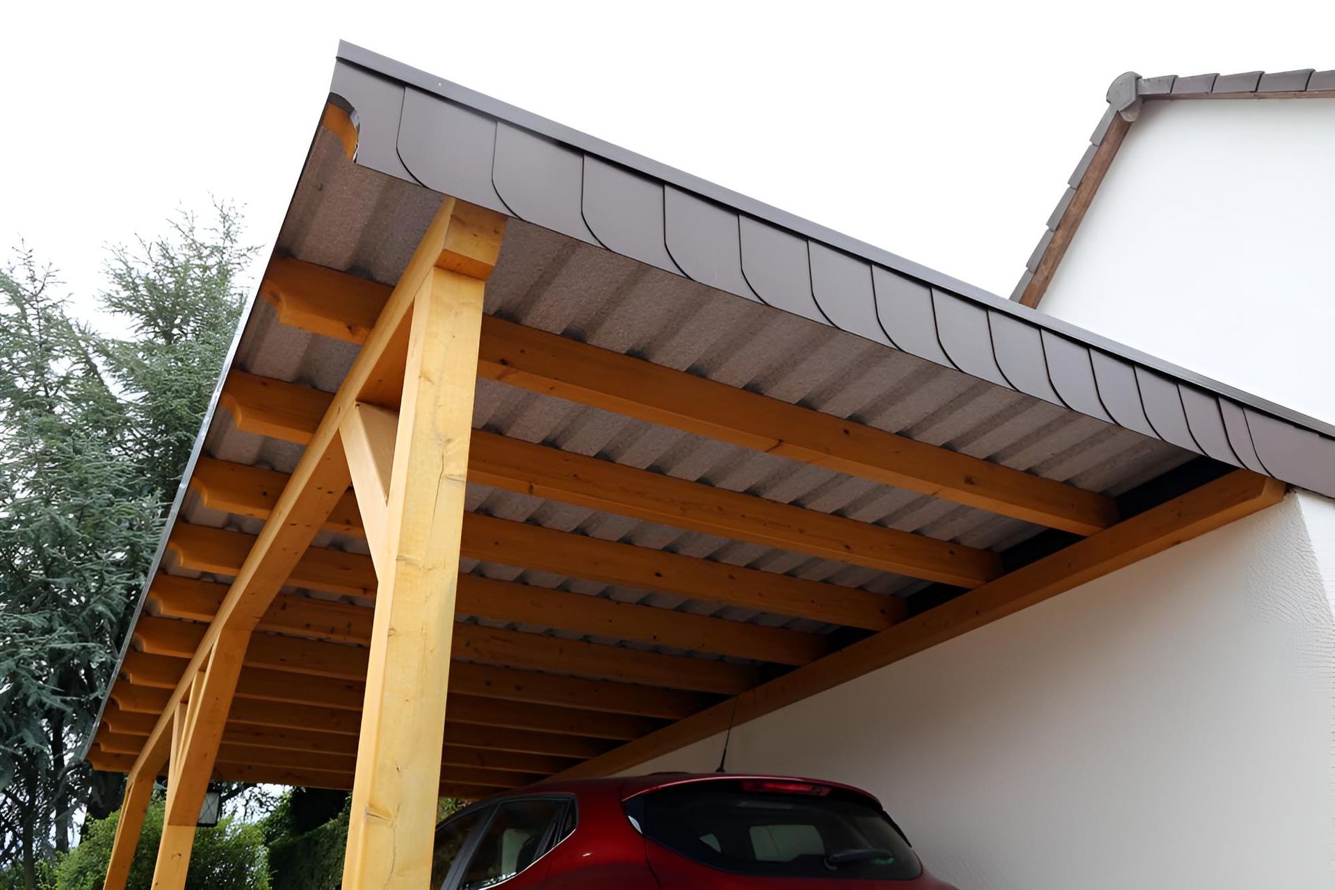 A Man Is Standing On Top Of A Red Roof — LJG Plumbing In Sarina, QLD