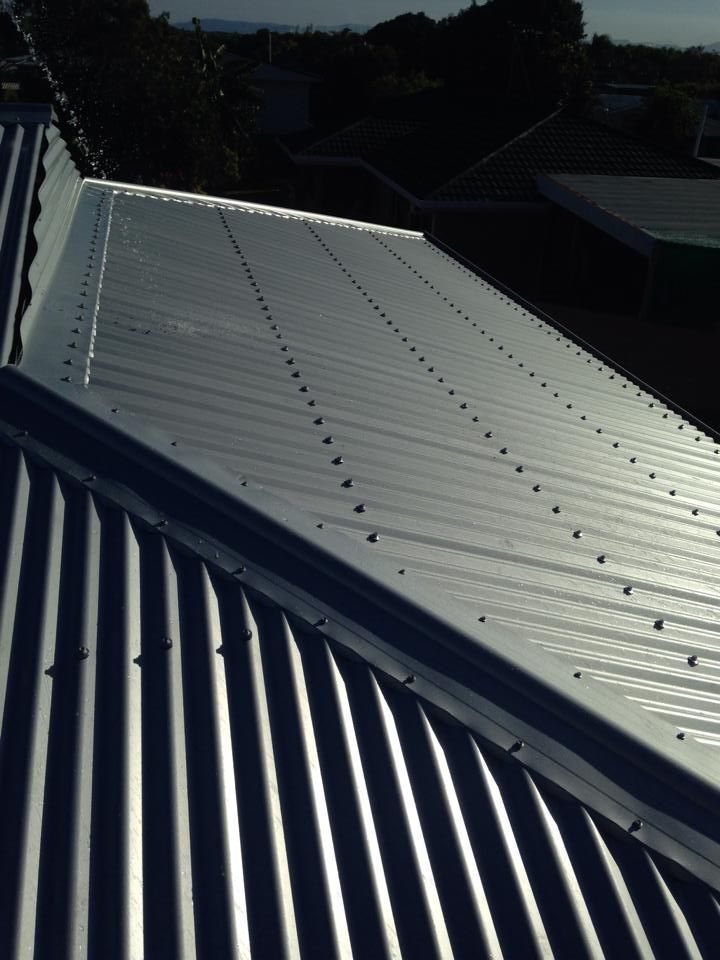 Silver Corrugated Metal Roof With Rows of Rivets — LJG Plumbing In Sarina, QLD