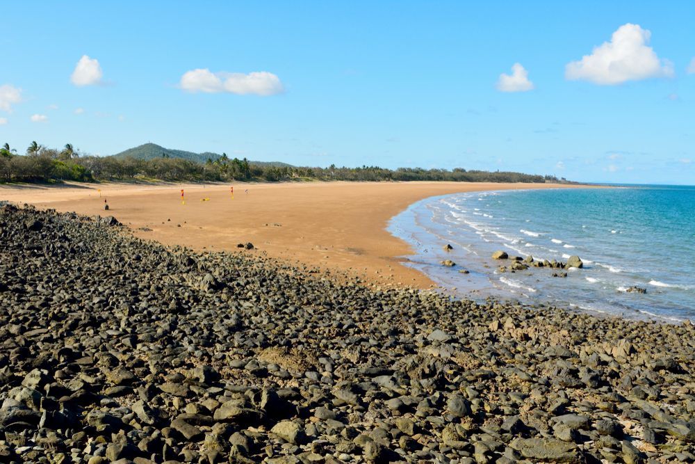 Rocky Shoreline Beside Sandy Beach, Blue Ocean and Sky — LJG Plumbing In Sarina, QLD