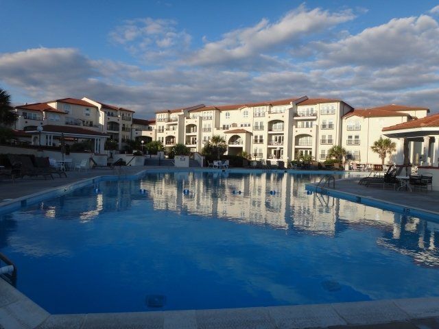 A large swimming pool in front of a large building
