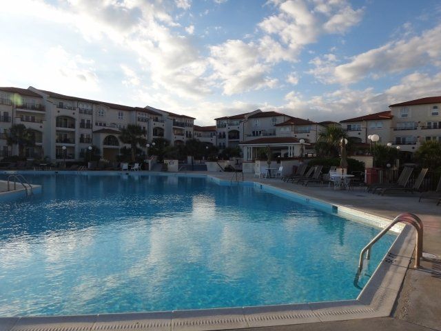 A large swimming pool with buildings in the background