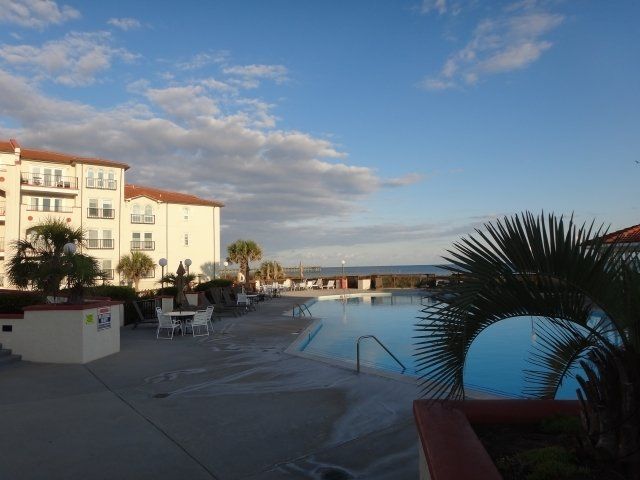 A large swimming pool in front of a large building