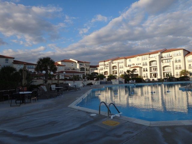 A large swimming pool in front of a large building