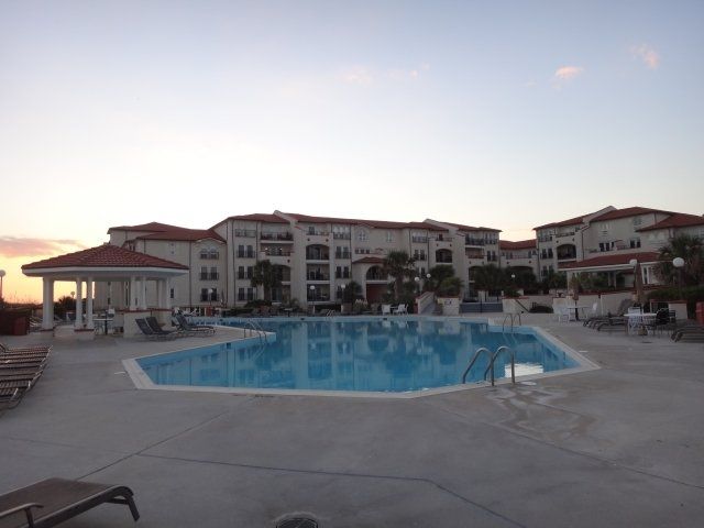 A large building with a pool in front of it