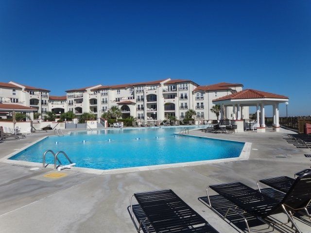 A large swimming pool in front of a large building