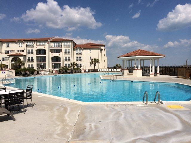 A large swimming pool in front of a large building