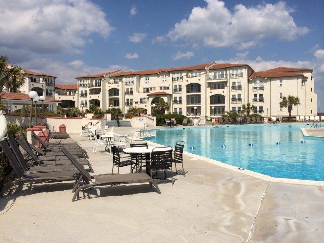 A large building with a swimming pool in front of it