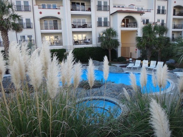 A large building with a swimming pool in front of it