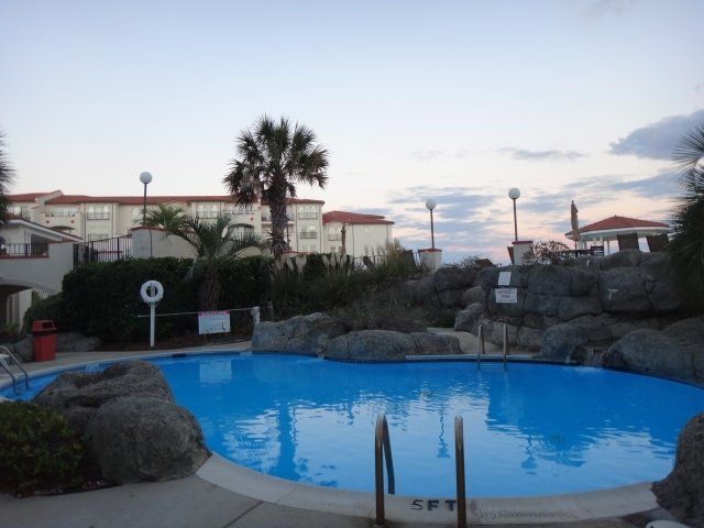 A large swimming pool with stairs leading to it