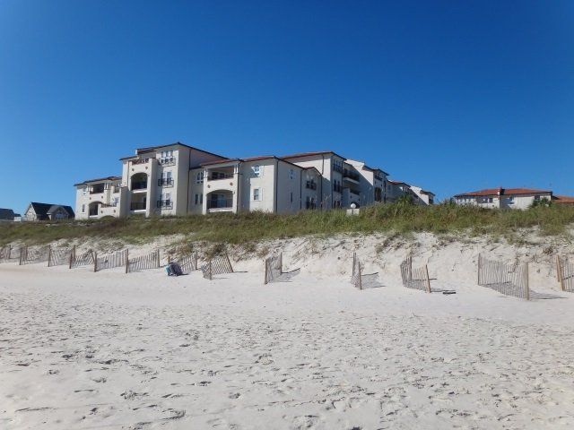 A beach with a large building in the background